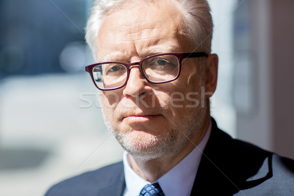 Stock photo: close up of senior businessman in eyeglasses