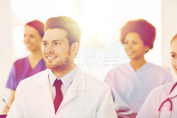 happy doctor over group of medics at hospital Stock photo © dolgachov