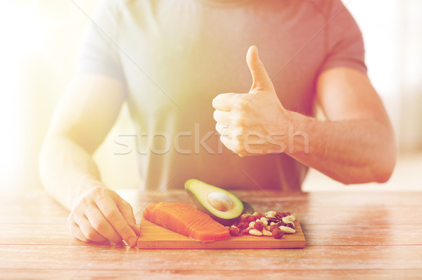 close up of male hands with food rich in protein Stock photo © dolgachov