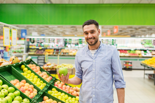 happy man buying green apples at grocery store Stock photo © dolgachov