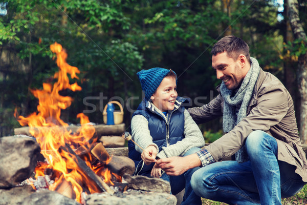 Stock photo: father and son roasting marshmallow over campfire