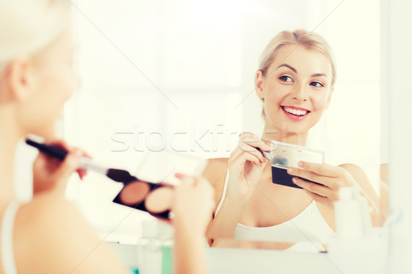 woman with makeup brush and foundation at bathroom Stock photo © dolgachov