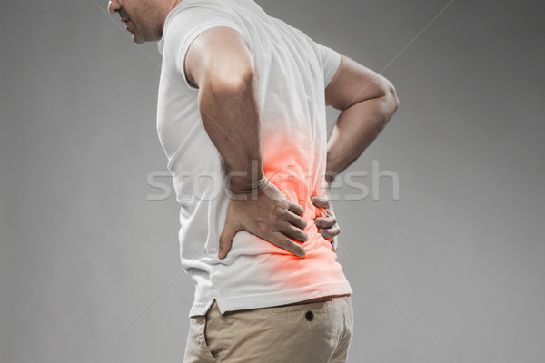 Człowiek cierpienie ból w krzyżu ludzi opieki zdrowotnej Zdjęcia stock © dolgachov