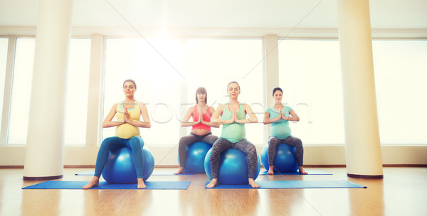 Stock photo: happy pregnant women exercising on fitball in gym