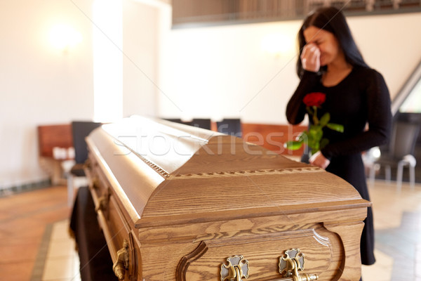 woman with coffin crying at funeral in church Stock photo © dolgachov