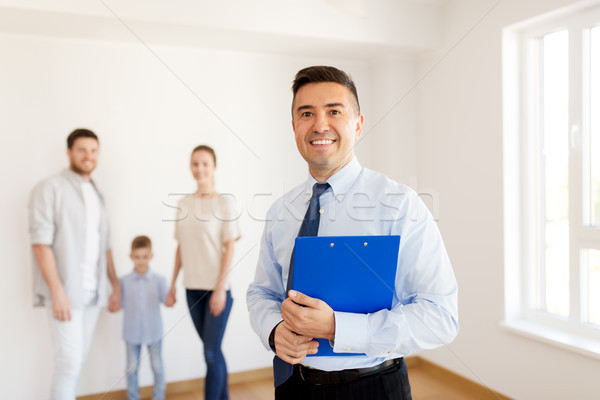 realtor with clipboard and family at new home Stock photo © dolgachov