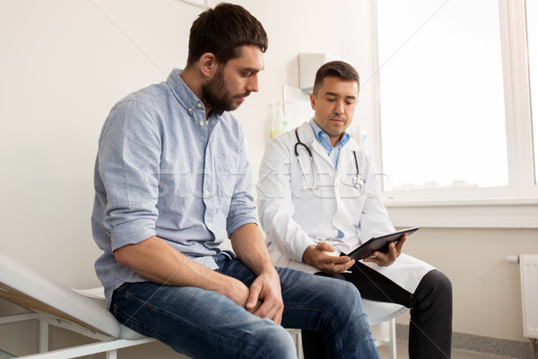 Stock photo: doctor and man with health problem at hospital