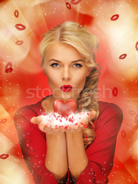 woman blowing kisses on the palms of her hands Stock photo © dolgachov
