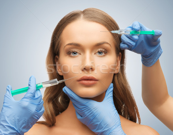 woman face and beautician hands Stock photo © dolgachov