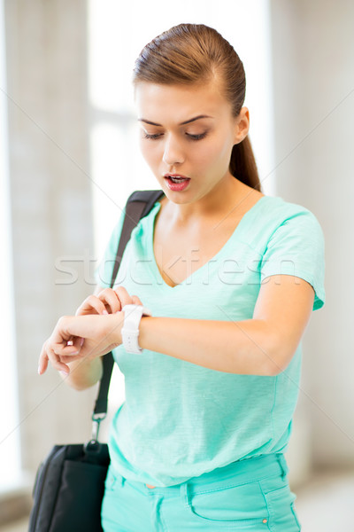 surprised student girl looking at clock Stock photo © dolgachov