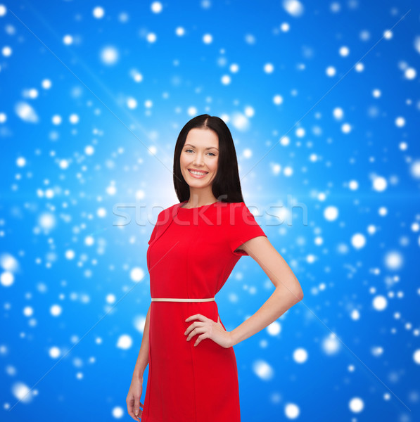 smiling young woman in red dress Stock photo © dolgachov
