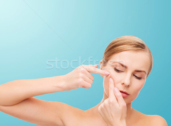 young woman squeezing acne spots Stock photo © dolgachov