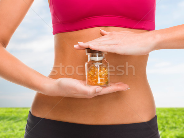 close up of female hands with bottle of capsules Stock photo © dolgachov