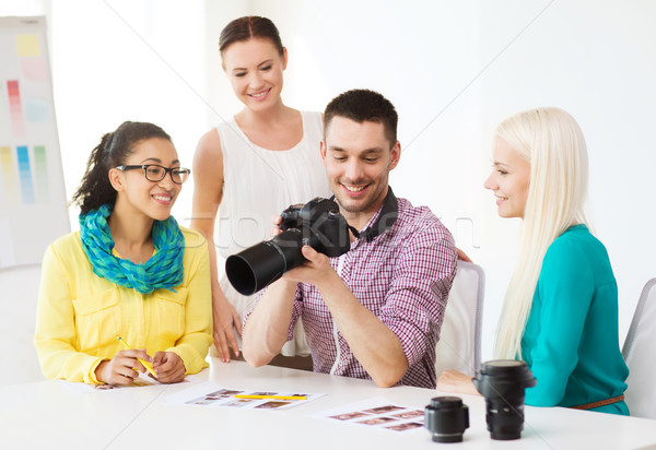 smiling team with photocamera working in office Stock photo © dolgachov