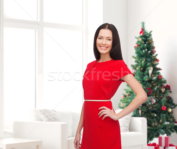 Lächelnde Frau roten Kleid Feiertage Feier Menschen Wohnzimmer Stock foto © dolgachov