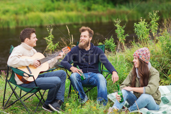 group of tourists playing guitar in camping Stock photo © dolgachov