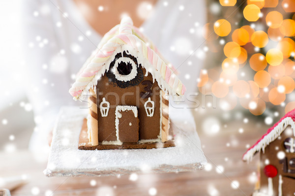 close up of woman showing gingerbread house Stock photo © dolgachov