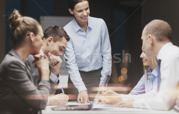 smiling female boss talking to business team Stock photo © dolgachov