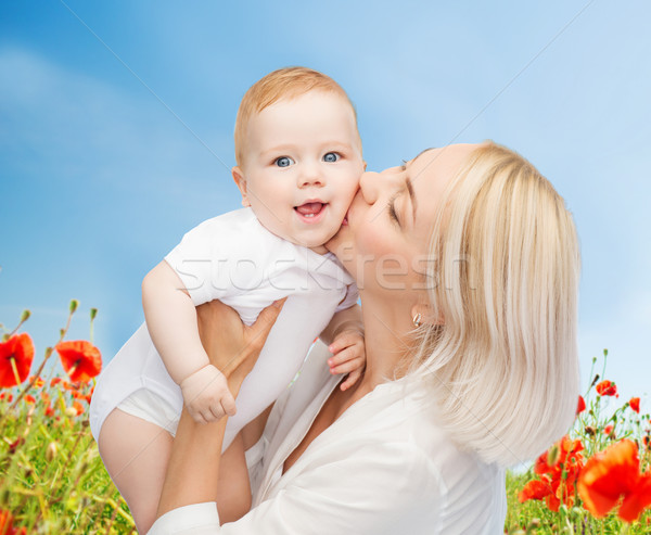 Stock photo: happy mother with baby over natural background