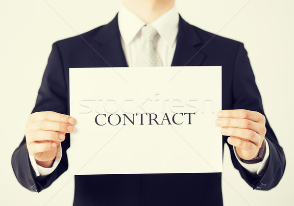 man hands holding contract paper Stock photo © dolgachov