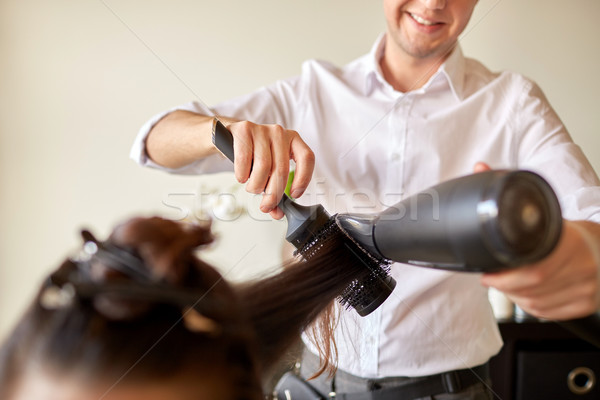  close up of stylist making hairdo at salon Stock photo © dolgachov