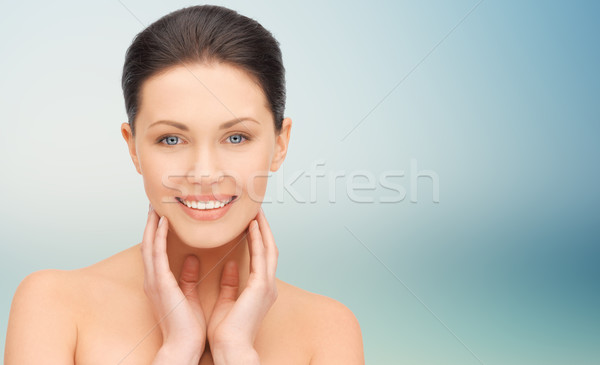 Stock photo: beautiful young woman touching her face and neck