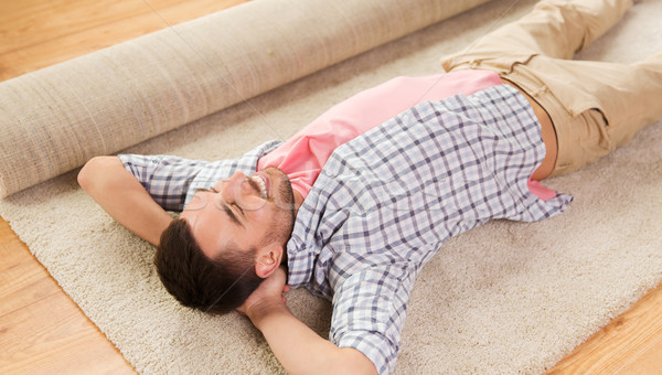 happy man lying carpet or rug at home Stock photo © dolgachov