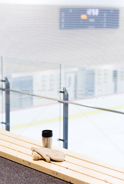 thermos cup and mittens on bench at ice rink arena Stock photo © dolgachov