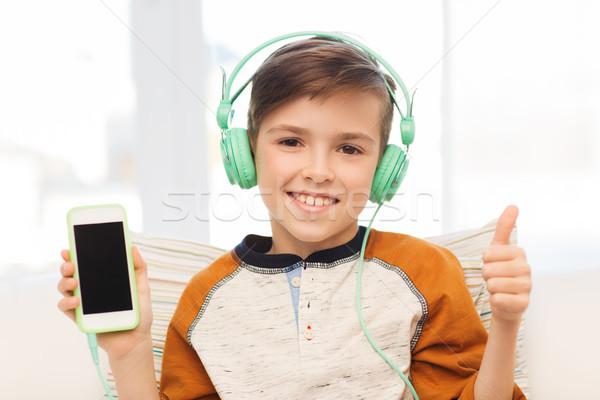 智能手機 頭戴耳機 家 閒暇 孩子 商業照片 © dolgachov