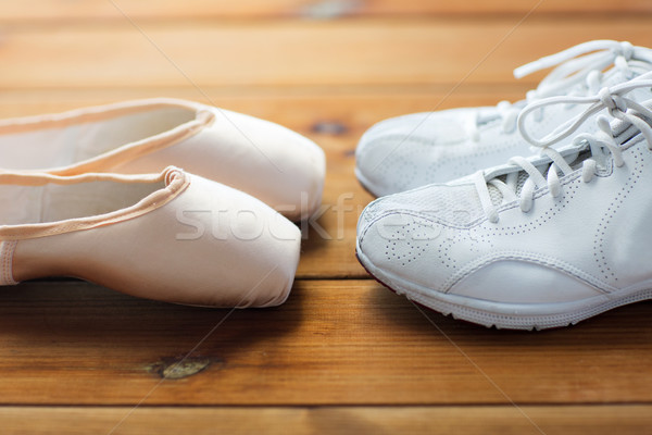 close up of sneakers and pointe shoes on wood Stock photo © dolgachov