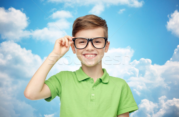 happy boy in green polo t-shirt and eyeglasses Stock photo © dolgachov