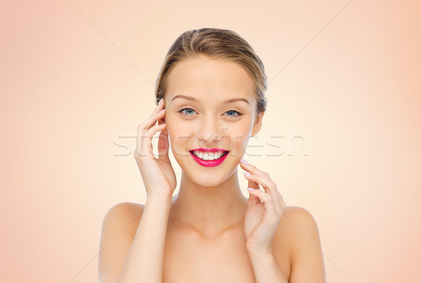 smiling young woman with pink lipstick on lips Stock photo © dolgachov