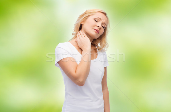 unhappy woman suffering from neck pain Stock photo © dolgachov