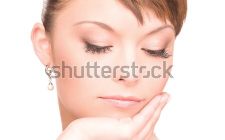 Stock photo: close up of beautiful woman face with earring