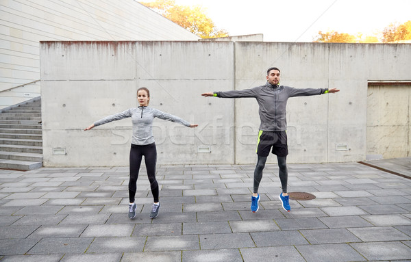 happy man and woman jumping outdoors Stock photo © dolgachov