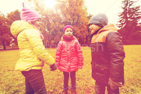 group of happy children talking in autumn park Stock photo © dolgachov