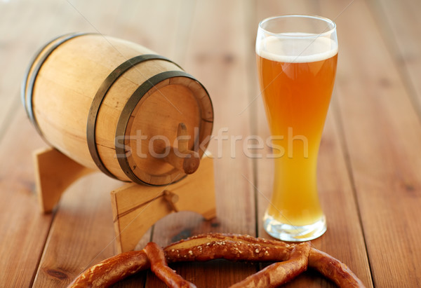 close up of beer glass, pretzel and wooden barrel Stock photo © dolgachov