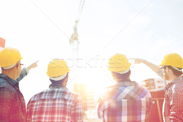 group of builders in hardhats at construction site Stock photo © dolgachov