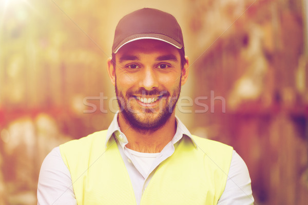 happy man in reflective safety vest at warehouse Stock photo © dolgachov