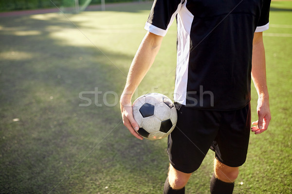 soccer player with ball on football field Stock photo © dolgachov