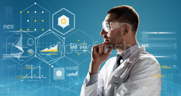 doctor or scientist in lab coat and safety glasses Stock photo © dolgachov