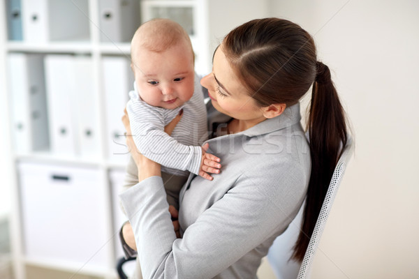 happy businesswoman with baby at office Stock photo © dolgachov