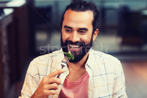 happy man having dinner at restaurant Stock photo © dolgachov