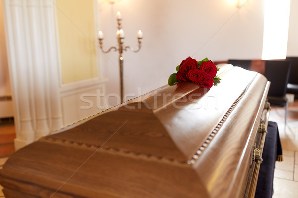red rose flowers on wooden coffin in church Stock photo © dolgachov