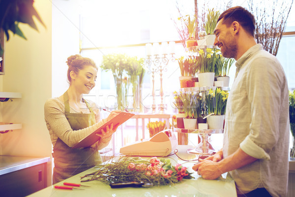 florist woman and man making order at flower shop Stock photo © dolgachov