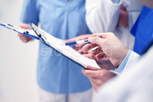 close up of doctors with clipboard at hospital Stock photo © dolgachov