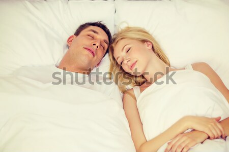 happy couple sleeping in bed at home Stock photo © dolgachov