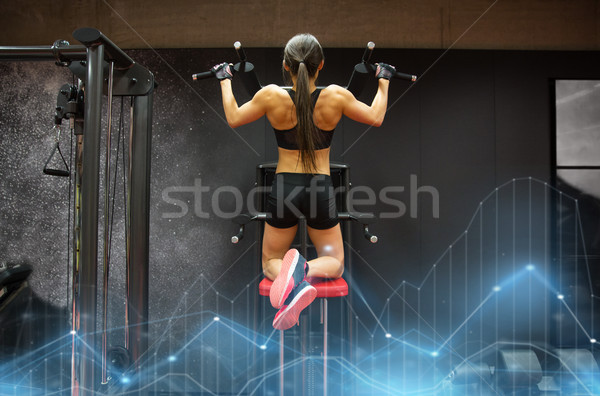 woman exercising and doing pull-ups in gym Stock photo © dolgachov