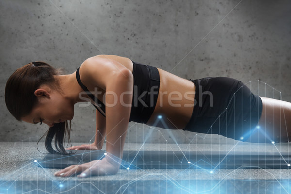 woman doing push-ups in gym Stock photo © dolgachov