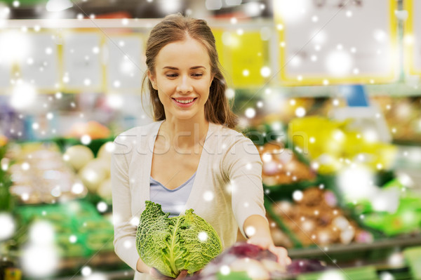 happy woman buying savoy at grocery store Stock photo © dolgachov